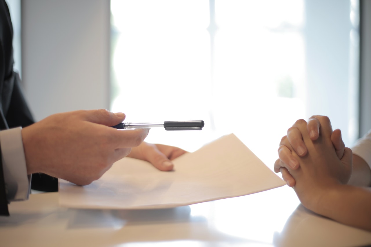 Attorney Handing Pen Over to the Client