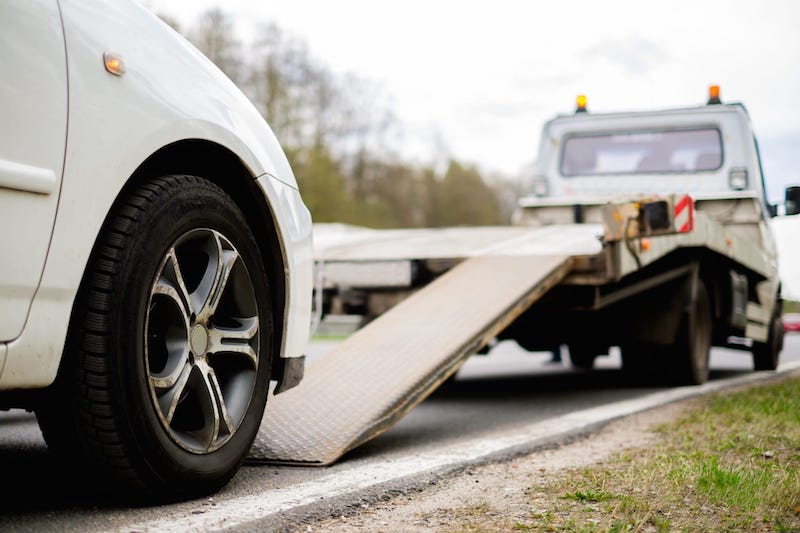 White Car Being Towed